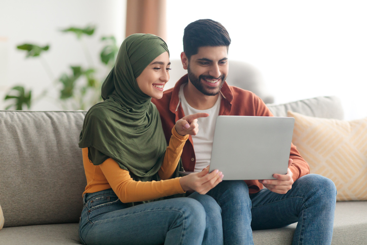 A young couple uses a tablet together