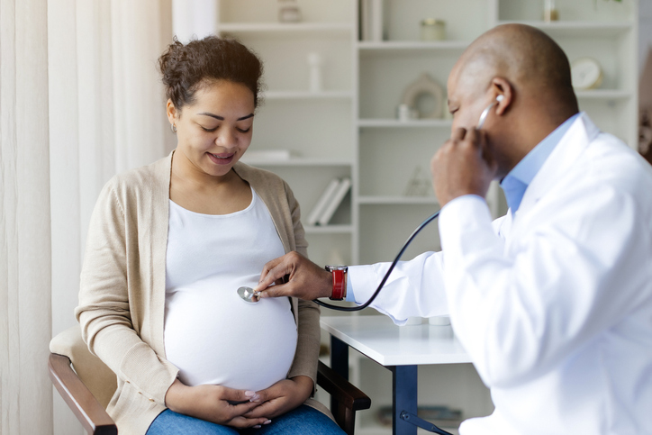 pregnant woman gets checkup from doctor