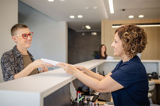 A patient talking with an office administrator