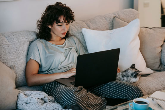 A woman working on her laptop at home