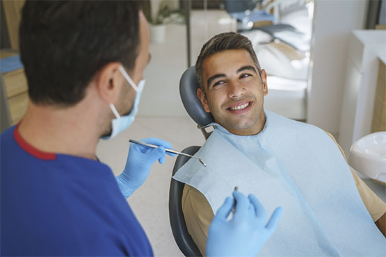A smiling patient receives dental care at a dentist