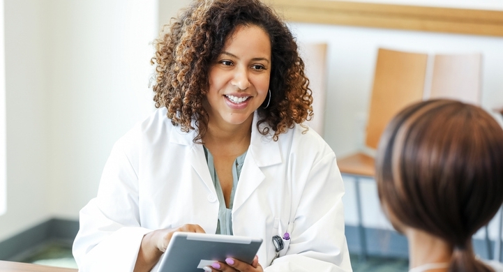 A smiling doctor advises her patient