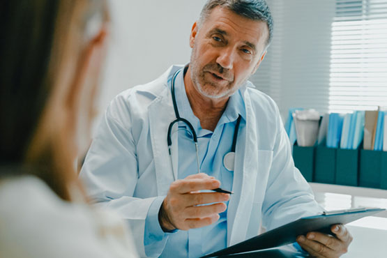 A doctor discusses care details with a patient