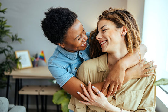 modern couple embraces with smiles