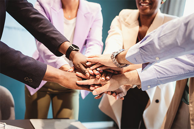Leaders' hands coming together as one team