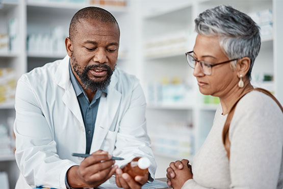 A doctor reviews presecription details with a patient