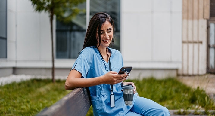 A Michigan healthcare provider reading information on their phone