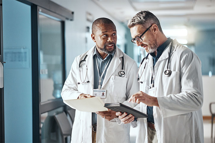 two doctors discuss medical care in a hospital