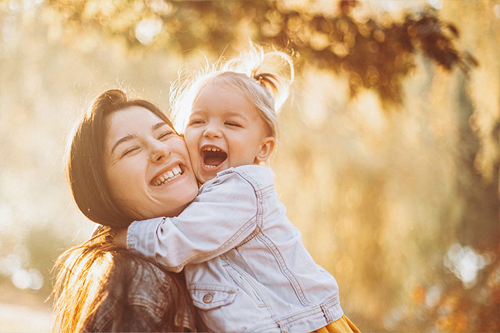 An image of a mom and daughter hugging